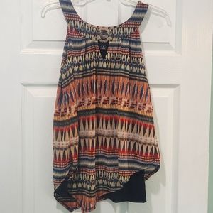 3/$15 Multicolored sleeveless top with handkerchief hem.